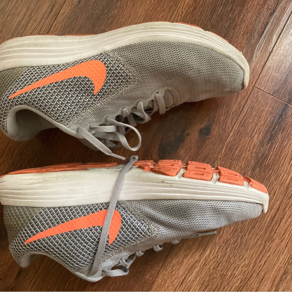 Gray Nikes with orange accents